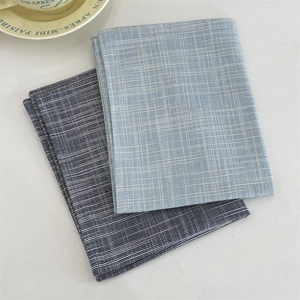 Detail of blue and light blue plaid linen placemats with fine texture and stitching