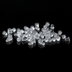 Bulk clear silicone earring backs with bullet shape design on black background