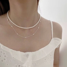 Detail of s925 silver perfume bottle necklace with white pearls and delicate double layer chain