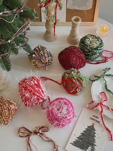 Cozy Christmas DIY mixed yarn rolls with festive decor, candles and holiday cards