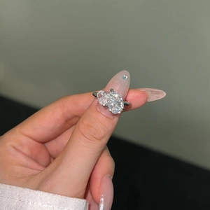 Macro view of a S925 silver double pear-shaped zircon ring showcasing brilliant fire