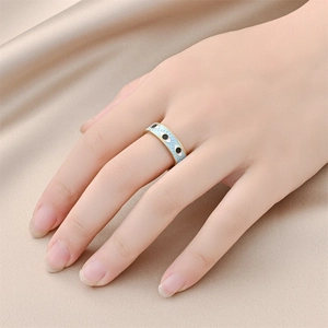 Chic gold stainless steel evil eye ring with light blue enamel on elegant silk background