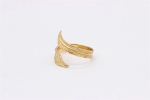 Detailed view of golden feather ring with intricate engraved textures and open-band design