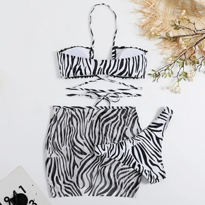 Zebra print three-piece bikini set featuring halter top and matching mesh sarong skirt