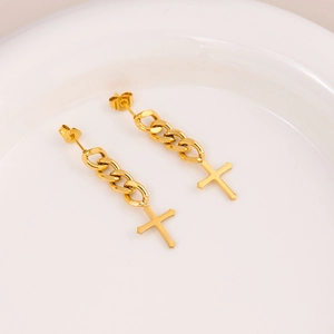 Cool gold cross stud earrings with tassel chain fringe in a minimalist white dish