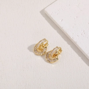 Macro view of interlocking gold zircon earrings with fine rectangular cut stones