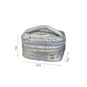 Detailed view of silver quilted makeup bag with dimensions 23cm by 17cm by 16cm