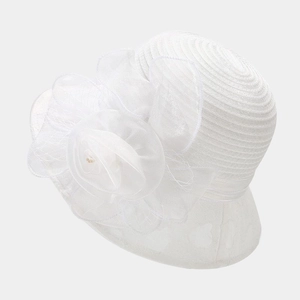 Detail of elegant white organza floral decoration and pearls on a formal bridal hat