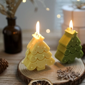 Close-up of yellow and green Christmas tree scented candles with festive decorations