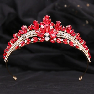 Macro detail of bridal crown with red crystals and silver rhinestones on black silk