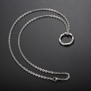 Silver Mobius ring necklace with Road Here engraving on black background