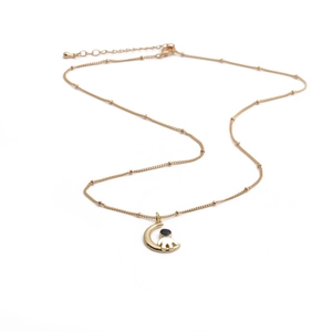 Golden moon and astronaut pendant necklace with micro-pave cubic zirconia on a beaded chain