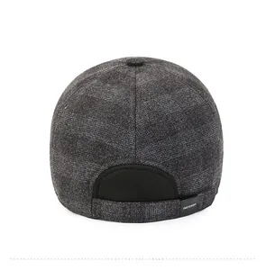 Rear view of a warm grey plaid baseball cap showing textured wool fabric and back strap