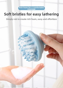 Detail of soft blue silicone scalp massager brush with thick cleaning foam lather