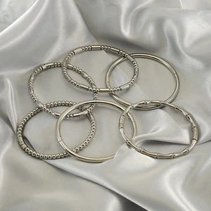 Minimalist vintage stainless steel silver bangle set of 6 on elegant silk fabric