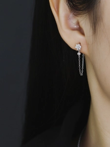 Detail view of S925 silver plum blossom tassel earring with crystals on model's ear