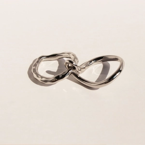 Minimalist silver intertwined double ring with smooth and hammered metal textures