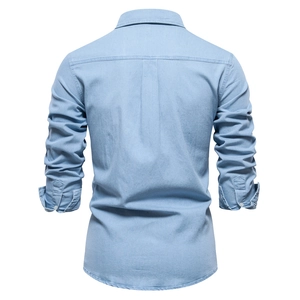 Back view of a light blue long-sleeve denim shirt showing fabric texture and clean stitching