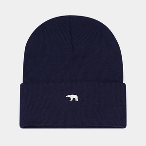 Close-up of navy blue knit beanie featuring a white polar bear embroidery detail