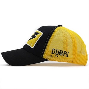 Detail of 3D embroidery and mesh material on a black and yellow baseball cap