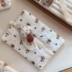 Quilted beige cosmetic bag with cute bear patterns and pearl chain charm detail
