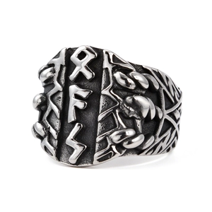 Vintage stainless steel Viking rune ring with embossed Nordic letters on white background