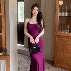 Detail showing the elegant slim fit magenta maxi dress with thin straps and fishtail hem