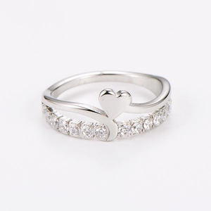 Close-up of double-layered stainless steel ring with heart shape and sparkling crystals
