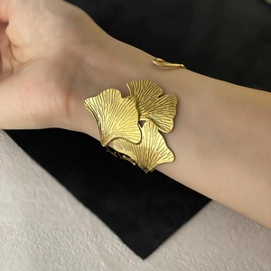 Detailed close-up showing the fine texture of the golden ginkgo leaf open cuff bracelet