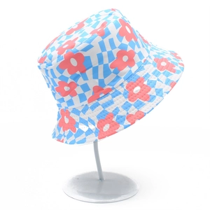Detail of floral and blue checkered reversible bucket hat on a display stand