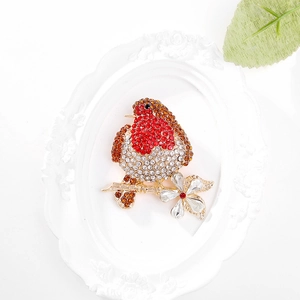Elegant gold-tone robin bird brooch with red and brown rhinestones on a branch