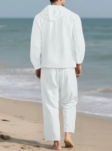 Men's white cotton linen hooded shirt and pants set back view on a beach background