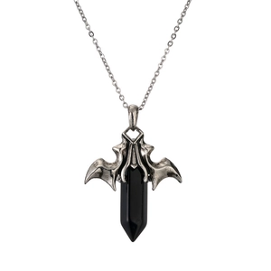 Macro shot of Gothic bat wings holding a black hexagonal crystal pillar on silver chain