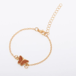 Close-up of adjustable gold chain bracelet with a brown enamel butterfly charm
