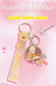 Detail of pink crystal liquid sand bear keychain with floating glitter and star strap