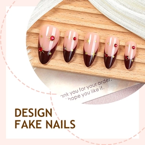 Handmade red cat eye press-on nails with diamonds and gold star accents in almond shape