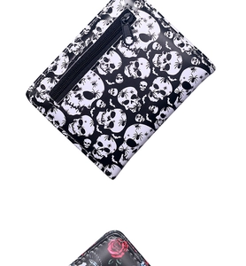 Detail of bifold wallet featuring gothic spider skull and red rose prints on PU leather