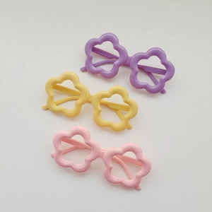 Detailed view of kids flower shaped sunglasses in purple yellow and pink macaron colors