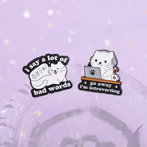 Detail of funny cat enamel pins featuring witty text on high-quality metal finish
