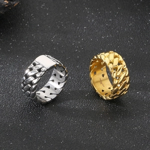 Macro shot of silver and gold Cuban link rings in polished stainless steel for men