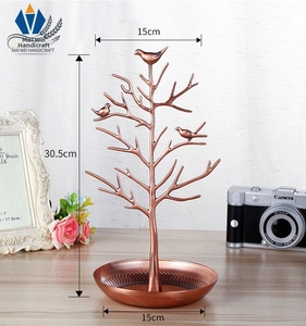 Macro shot of copper jewelry organizer stand with bird accents and 30.5cm height dimension