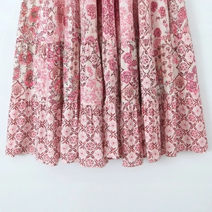 Floral print layered midi skirt with pink vintage patterns and flowing fabric texture