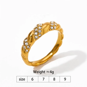 Detail of twisted gold ring with diamond cubic zirconia accents and size guide table