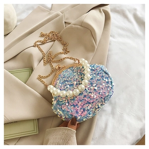 Detail of pink and blue sequin mini shell bag with pearl handle and golden chain