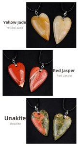Detail of natural heart-shaped crystal pendants in topaz, red jasper, and unakite stone