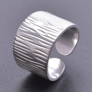 Detailed view of silver ring featuring natural bark texture and adjustable open band design