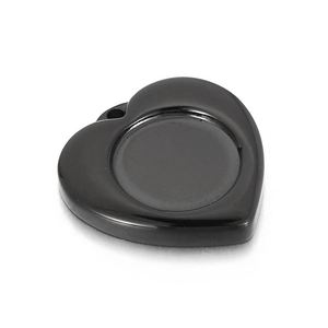 Macro view of black heart-shaped pendant base with smooth finish for DIY jewelry