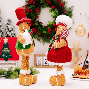 Detail of Christmas gingerbread couple dolls with retractable legs and knitted texture