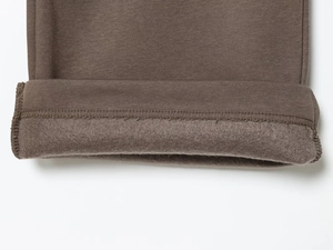 Detailed close-up of brown casual tracksuit showing the thick warm fleece lining and fabric