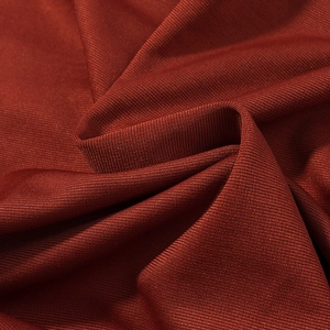 Detailed macro shot showing the fine ribbed texture and red-brown stretch fabric